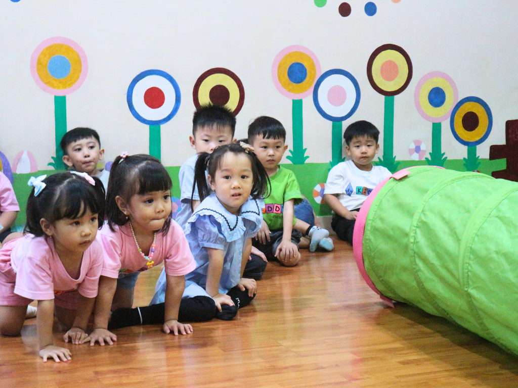 Group of playgroup students in a circle for activity time in class.